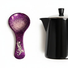 Load image into Gallery viewer, Purple glittery spoon with a decorative handle on a textured surface