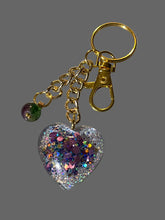 Load image into Gallery viewer, Mocs N More - Glitter Heart Keychain with Purple &amp; Green Glass Bead Charm