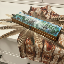 Load image into Gallery viewer, Decorative box with nature-themed design on a patterned fabric surface