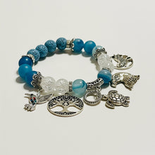 Load image into Gallery viewer, Blue beaded bracelet with silver charms on a white background