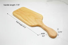 Load image into Gallery viewer, Wooden cutting board on a wooden surface with a workshop background