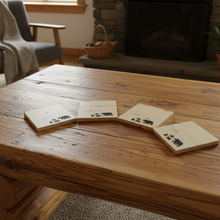 Load image into Gallery viewer, Four wooden coasters with animal illustrations on a gray background