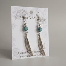 Load image into Gallery viewer, Pair of earrings with feather and bead design on a 'Moss N More' branded card.