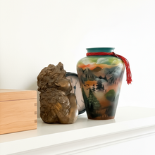 Load image into Gallery viewer, Decorative items including a vase with a nature design, a wooden box, and a stone lion figure on a white surface.