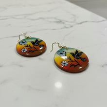 Load image into Gallery viewer, Pair of earrings with floral and bird design on a wooden surface
