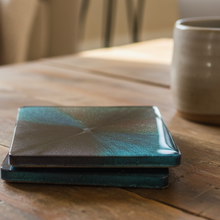 Load image into Gallery viewer, Two green ceramic coasters on a wooden surface