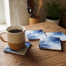 Load image into Gallery viewer, Mug of coffee on a wooden table with blue and white coasters