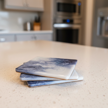 Load image into Gallery viewer, Stack of coasters on a kitchen counter with blurred background