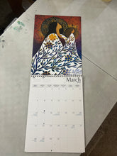 Load image into Gallery viewer, Calendar open to March with artistic design on a textured surface
