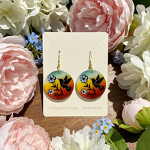 Load image into Gallery viewer, Pair of earrings on a card with floral background