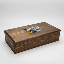 Load image into Gallery viewer, Wooden box with a metal eagle emblem on a workshop table.