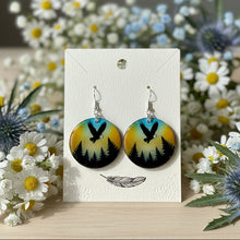 Load image into Gallery viewer, Pair of earrings on a card with flowers in the background