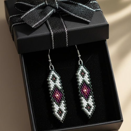 Beaded earrings in a black gift box with a bow