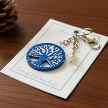 Load image into Gallery viewer, Tree of Life keychain on a card with 'Moco N' branding