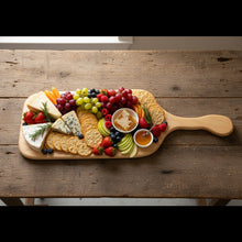 Load image into Gallery viewer, Wooden paddle on a workbench with tools and equipment in the background