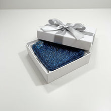 Load image into Gallery viewer, Blue glittery square object with a dragonfly on a brown surface