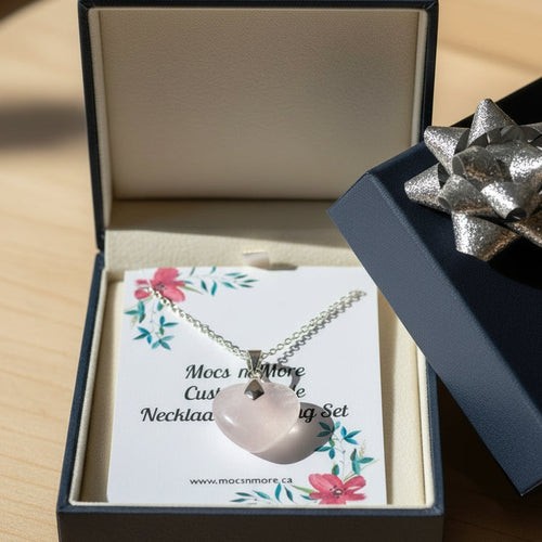 Necklace with a heart pendant in an open gift box with a bow