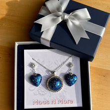 Load image into Gallery viewer, Jewelry set with blue heart-shaped pendants on a 'Mocs N More' card.