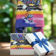 Load image into Gallery viewer, Colorful towel with eagle design in a white gift box on a blurred green background