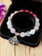 Load image into Gallery viewer, Beaded bracelet with a heart charm on a black jewelry box