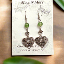 Load image into Gallery viewer, Butterfly earrings with green beads on a Mocs N More card.