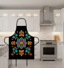 Load image into Gallery viewer, Black apron with colorful geometric design and paw prints on a white background