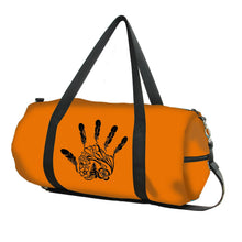Load image into Gallery viewer, Orange duffel bag with black handprint design on a white background
