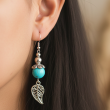 Load image into Gallery viewer, Close-up of Turquoise and Silver Earrings being worn
