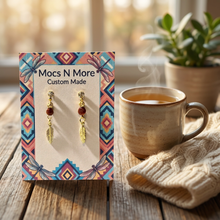 Load image into Gallery viewer, Earring card on a rustic table beside a mug of tea