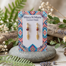 Load image into Gallery viewer, Earring card on a stone with soft greenery