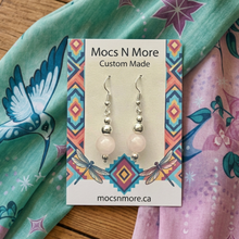Load image into Gallery viewer, Earrings on a Mocs N More card laid over the hummingbird scarf on a wood table