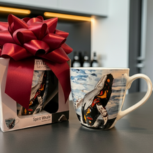 Load image into Gallery viewer, Gift box with a large red bow and a mug with a whale design on a kitchen counter.