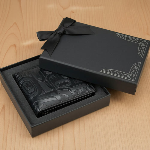 Black leather boot in an open black box on a white background