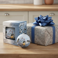 Load image into Gallery viewer, Decorative glass ornament with chickadees on branches, displayed with packaging.