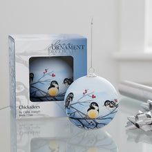 Load image into Gallery viewer, Decorative glass ornament with chickadees on branches, displayed with packaging.