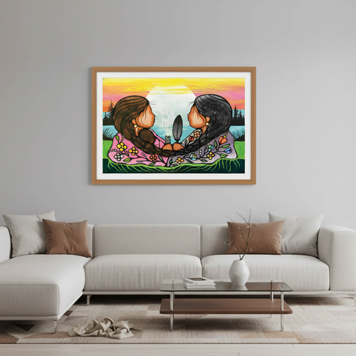 Framed artwork of two elephants embracing on a wall above a modern living room setup.