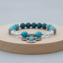 Load image into Gallery viewer, Turquoise Thunderbird bracelet on round board with natural elements - variation 1