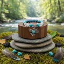 Load image into Gallery viewer, Turquoise Thunderbird bracelet on round board with natural elements - variation 3