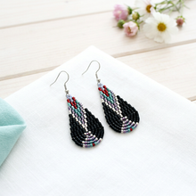 Load image into Gallery viewer, Wind Talker earrings styled on white linen